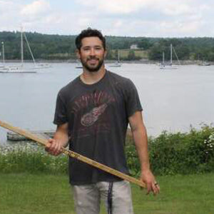Third Assist Founder, Christopher DeVore, holding his DIY hockey stick.